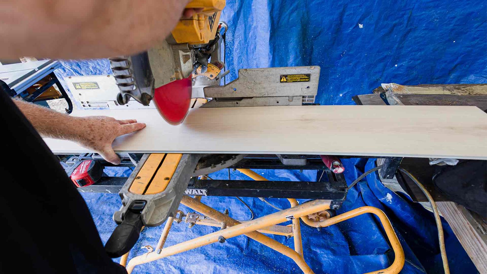 Rob cutting flooring with chop saw